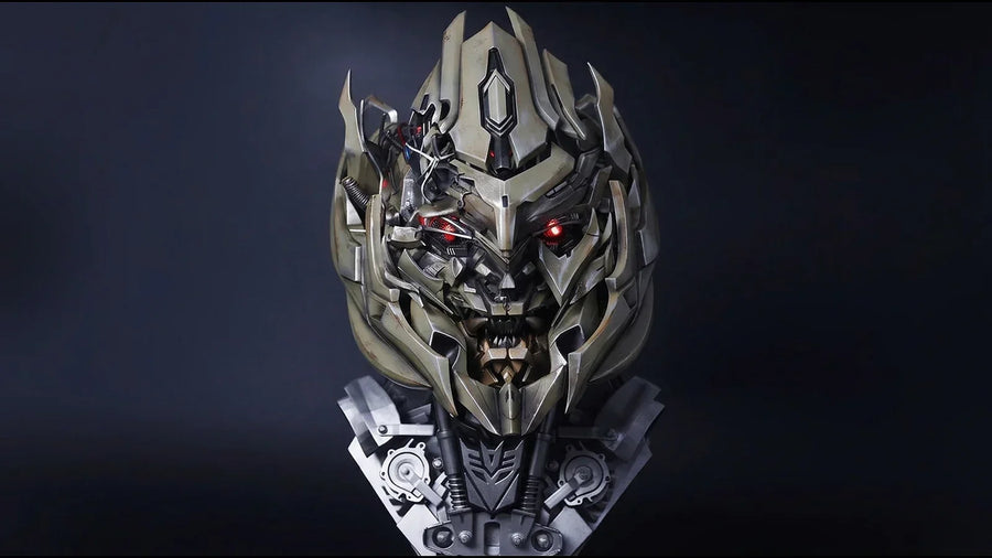 Megatron helmet with red eyes lit, front view on a dark studio background