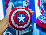 Captain America shield speaker held in one hand, showing its palm size