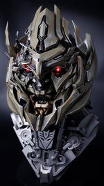 Megatron helmet with red eye lit, front three-quarter view on a Decepticon display base