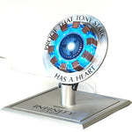 Iron Man Arc Reactor wireless charger lit blue on its Infinity Saga base