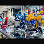 Optimus Prime and Bumblebee helmets displayed on Transformers helmet stands
