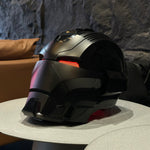 Matte black Dark Edition Iron Man MK17 helmet on a table, red eyes lit
