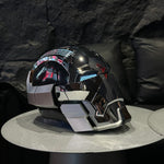 Black chrome Iron Man MK17 Heartbreaker helmet in profile on a table