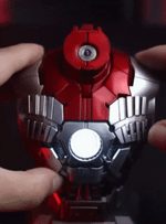 Hands lifting the magnetic head sculpt off the Iron Man MK5 bust