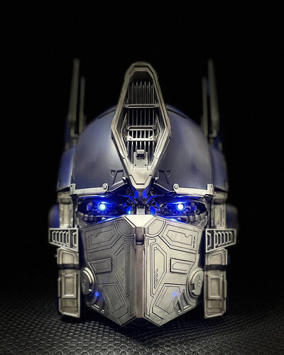 Optimus Prime helmet with blue LED eyes lit, front view, battle mask closed
